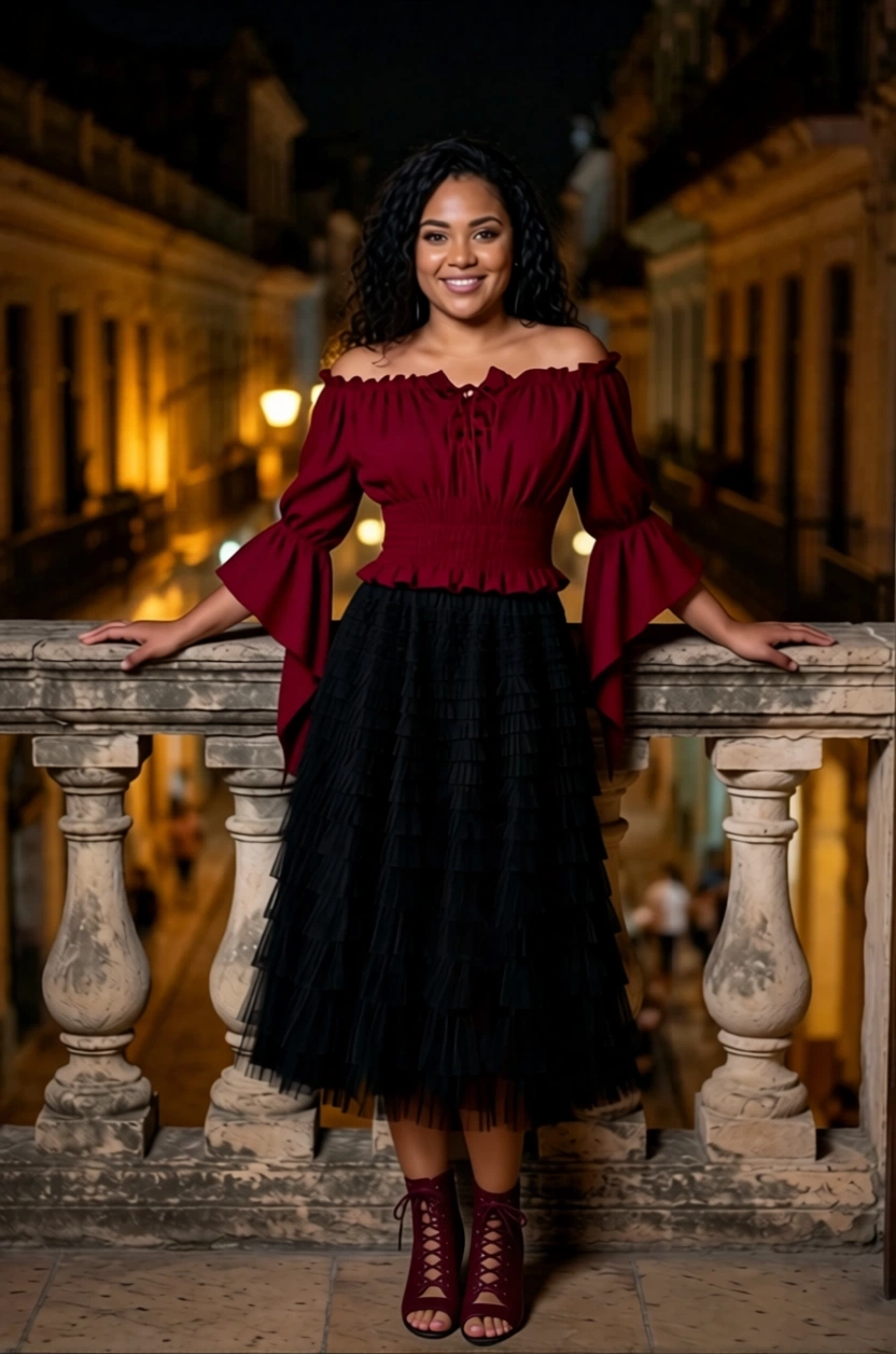 Woman in red top and black skirt standing on balcony at night in Cuba